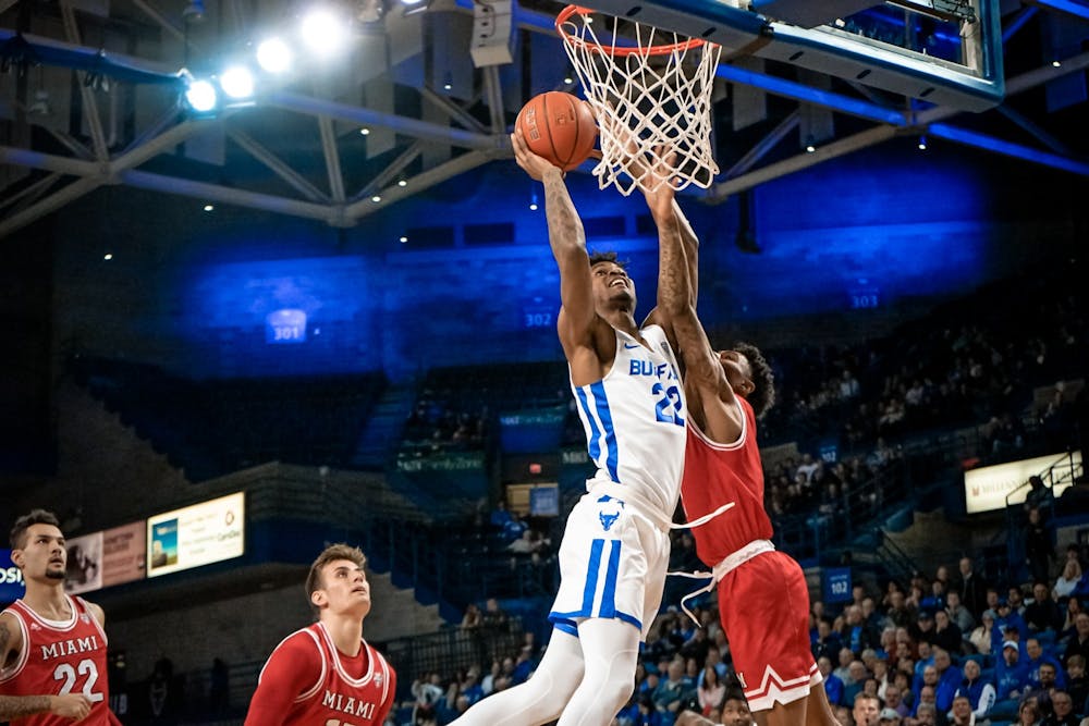 <p>Redshirt forward Laquill Hardnett being heavily guarded in the paint by a Miami defender.</p>