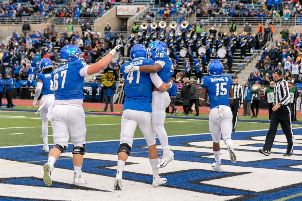 Junior quarterback Tyree Jackson celebrates with freshman running back Jaret Patterson after scoring in a game earlier this season. The Bulls broke the school record in rushing touchdowns this season with 32.