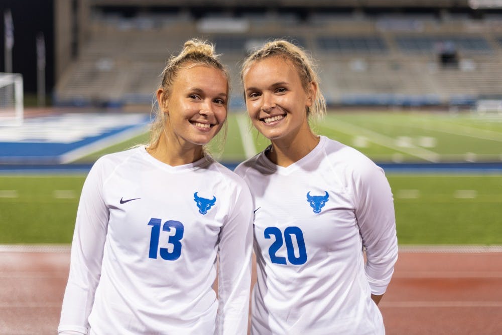 <p>The Callaghan twins pose after a Sept. 6 victory against Houston Baptist at UB Stadium.</p>