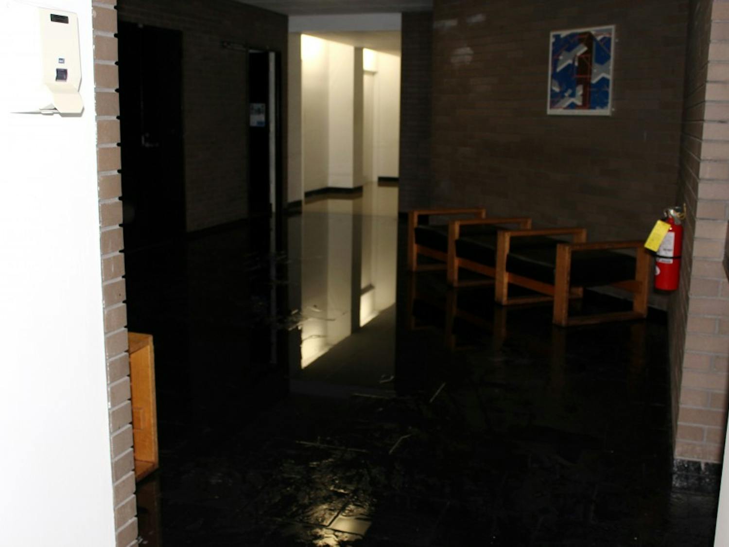 The fourth floor lobby of Clemens hall is flooded as a  result of a burst water valve on the fourth floor cooling system.