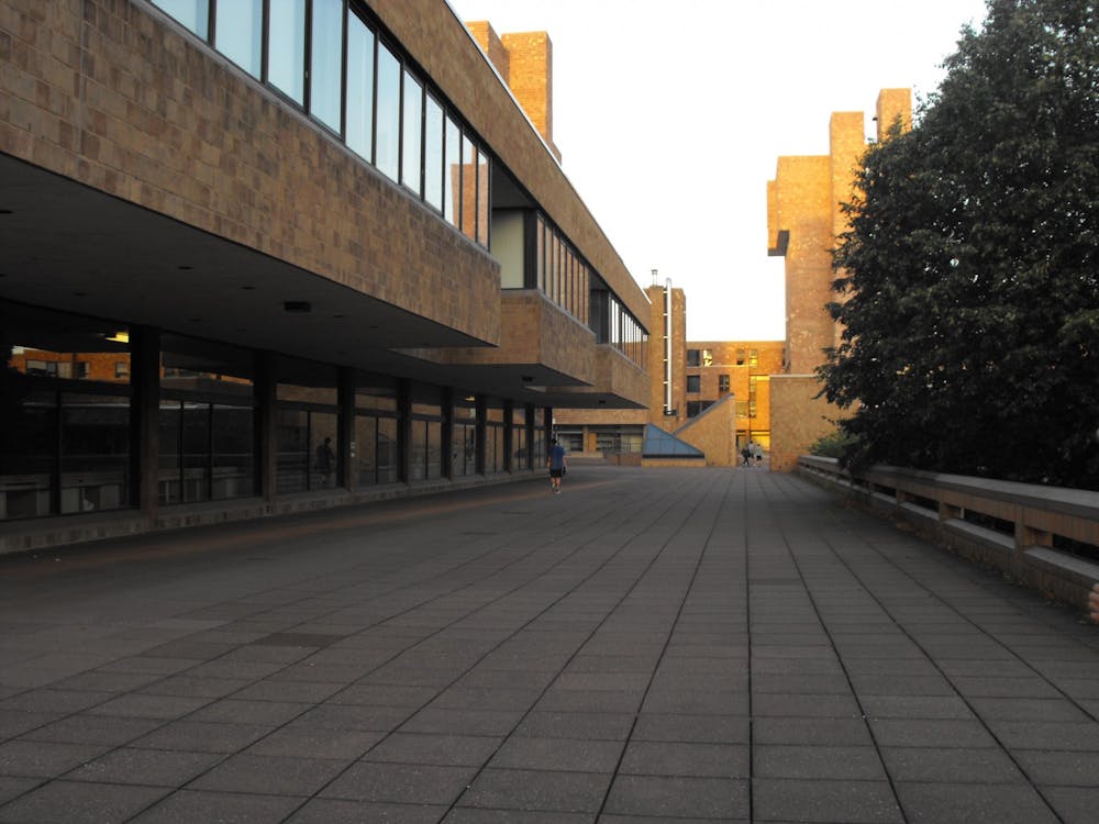 A student walks on the terrace of the Ellicott Complex.