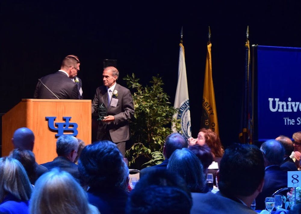 <p>Charles Severin, a ‘97 alum, accepting his award Friday during the Alumni Association Achievement Awards ceremony at the Center for the Arts. The ceremony recognizes alumni who have made significant impacts to the university community and society.&nbsp;</p>
