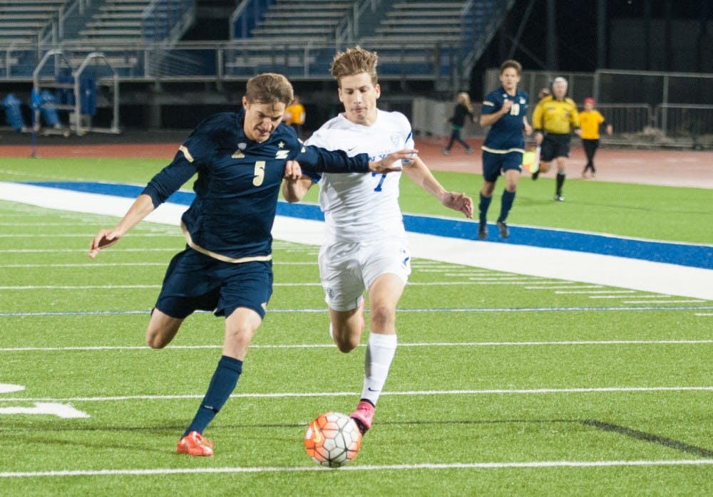 <p>Junior midfielder Russell Cicerone dribbles the ball down the field while trying to run past an Akron defender from last Friday’s MAC opener. Cicerone is the team's star player and is preparing for conference play.</p>