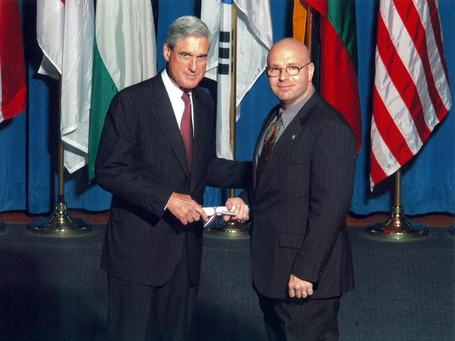Then-FBI Director Robert Mueller congratulates Josh Sticht on graduating from the FBI Academy in Quantico, Virginia.&nbsp;