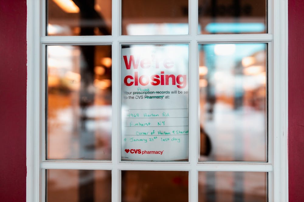 <p>A sign nestled in CVS’ doorway displays the store’s fate.</p>