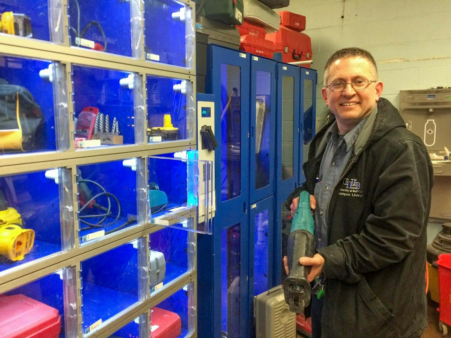 Vince Biondi, maintenance assistant with the Ellicott maintenance staff, takes a Sawzall tool out of a tool cage. Biondi and other maintenance workers deal with student concerns in all the Ellicott Complex dorm buildings.