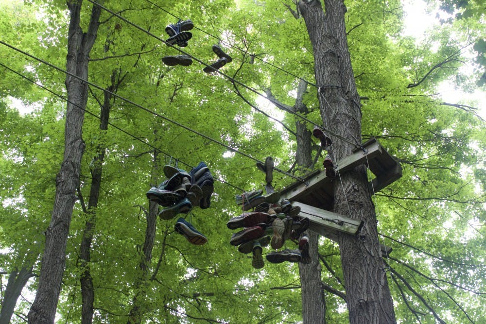 <p>Shoes hang from the ropes course located next to Sweet Home Senior High School. The course is no longer officially used by either school.</p>