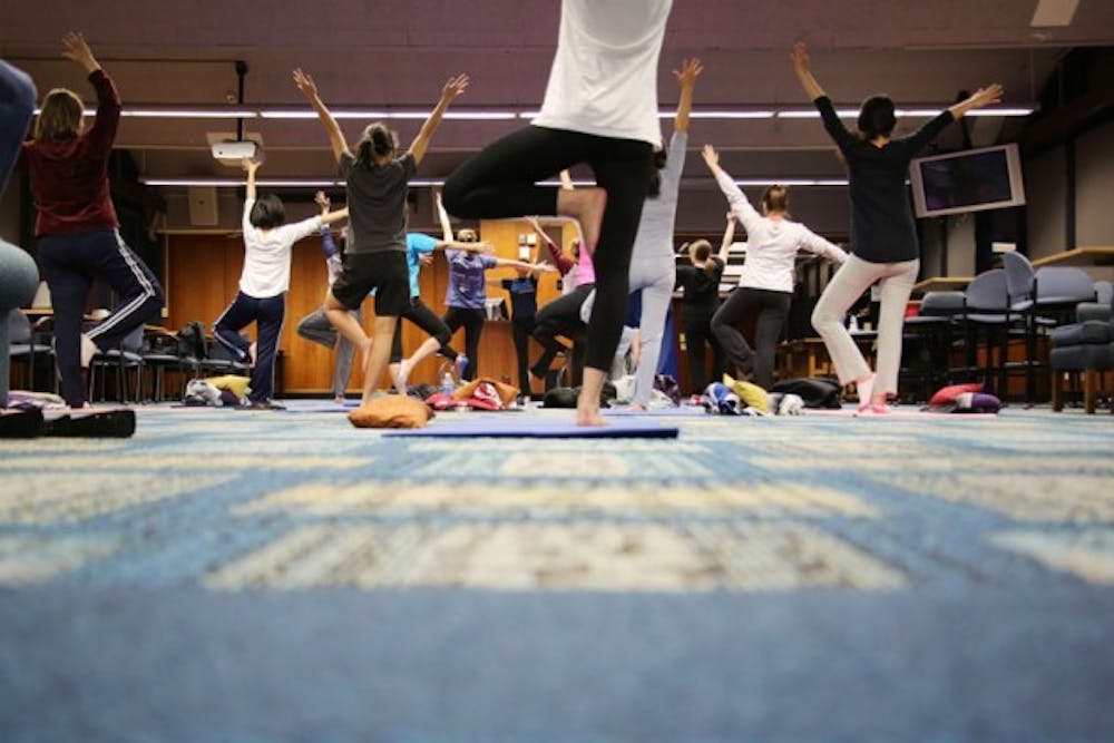 Students in Ulrike Carlino-Macdonald&rsquo;s Gentle Hatha Yoga class stretch, breathe and focus their way to relaxation and health every Wednesday at 5 p.m. on the 10th floor of Goodyear Hall on South Campus. The class is run by UB Wellness and Education Services.&nbsp;Harutyun Khachatryan, The Spectrum 