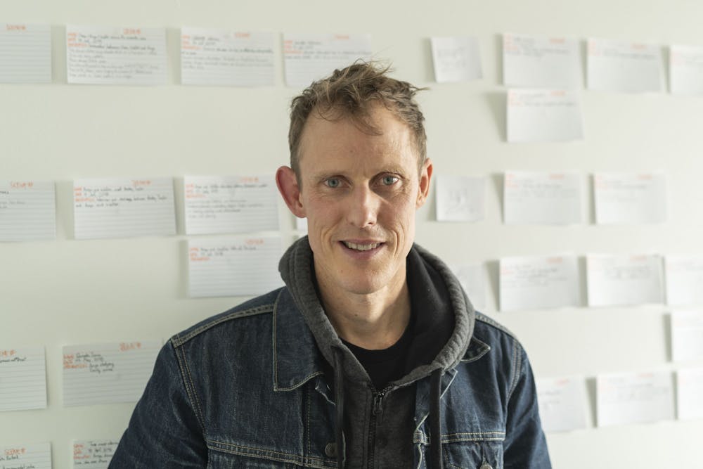 <p>DMS professor and filmmaker John Fiege in his office in the Center for the Arts.</p>