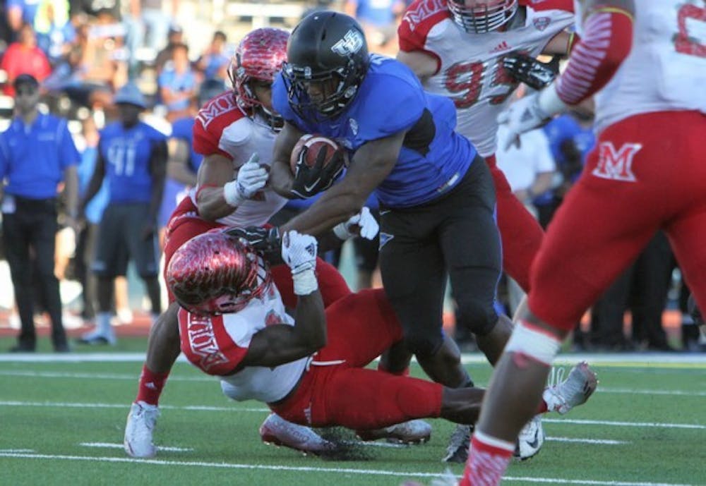 <p>Junior running back Anthone Taylor runs through a RedHawks defender during a 222-yard, three-touchdown performance in Buffalo's 35-27 victory over Miami Ohio on Sept. 27. Taylor, along with four teammates, were named to Phil Steele's preseason All-MAC team Monday. </p>