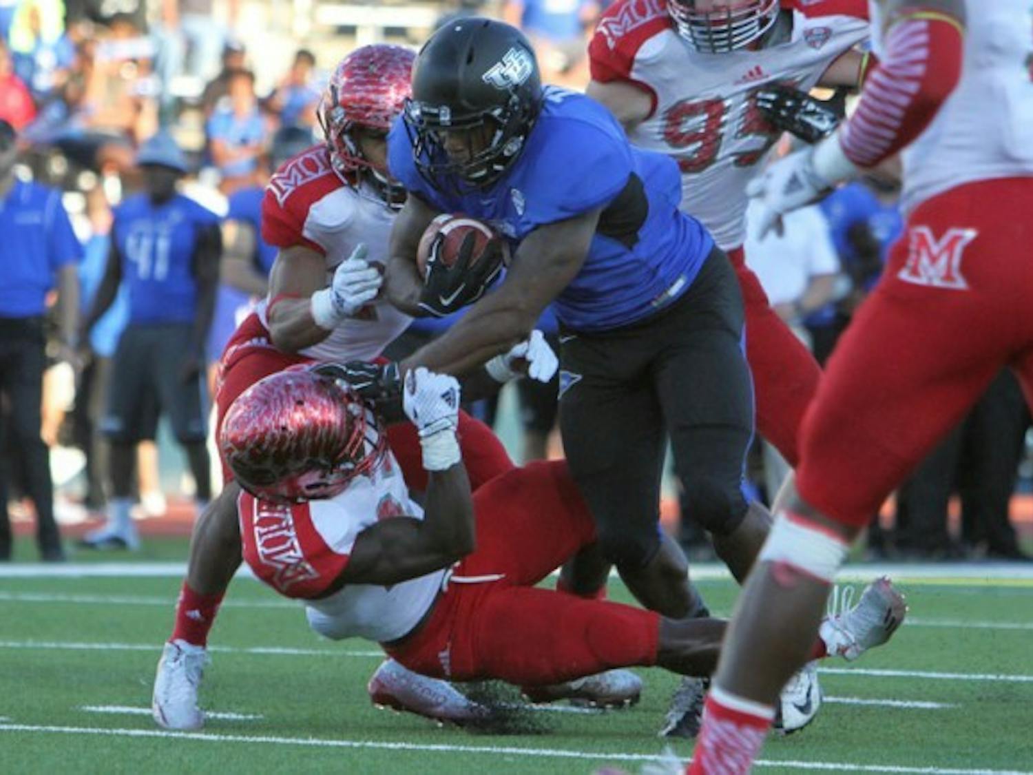 Junior running back Anthone Taylor runs through a RedHawks defender during a 222-yard, three-touchdown performance in Buffalo's 35-27 victory over Miami Ohio on Sept. 27. Taylor, along with four teammates, were named to Phil Steele's preseason All-MAC team Monday. 