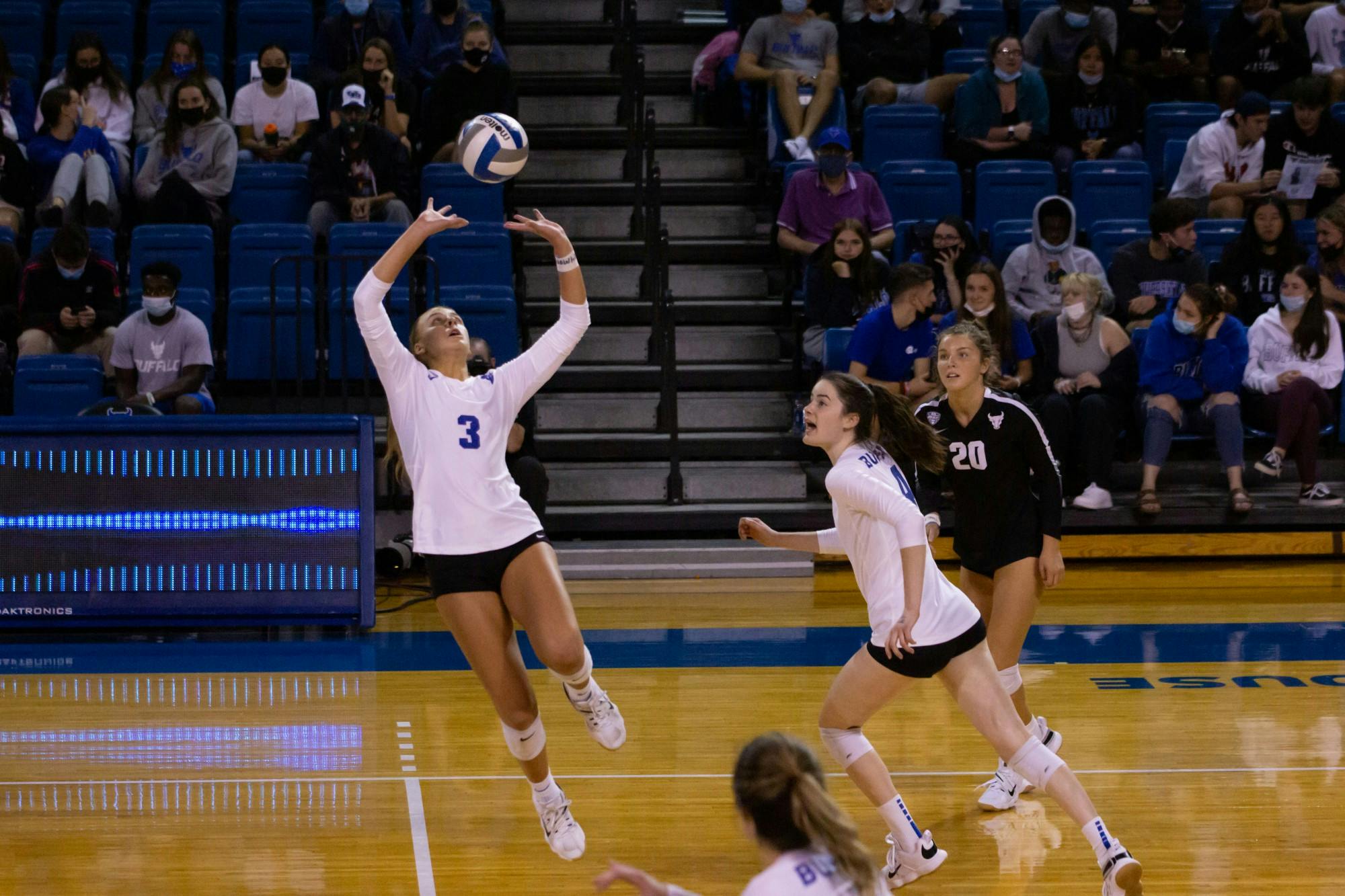 Freshman setter Mandy Leigh (3) and sophomore middle back Olivia Debertoli (4) take the court during a recent game.