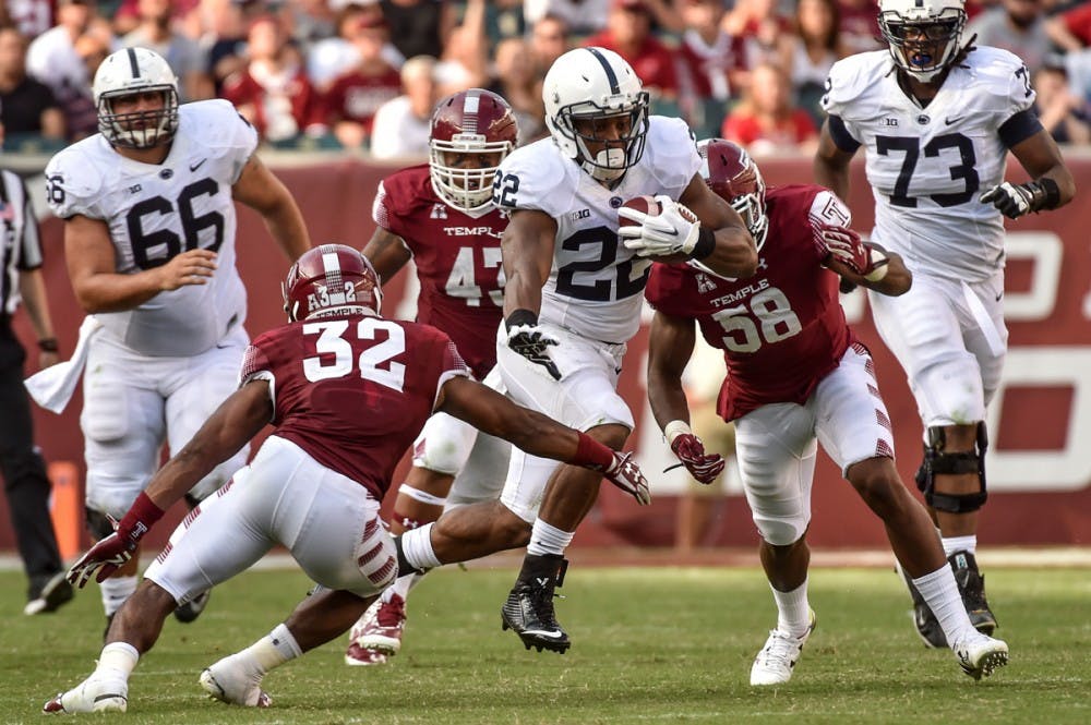 <p>Penn State running back Akeel Lynch looks to break a tackle against a Temple defender. Penn State defeated the Bulls 27-14 Saturday. </p>