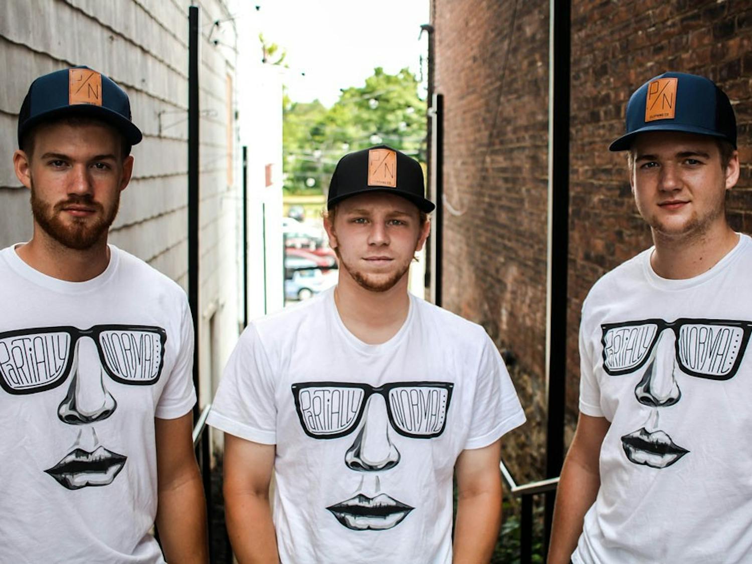 Brendan Cox, Ryan Thompson and Evan Cox the creators of Partially Normal Clothing. They currently have hats and t-shirts for sale but plan to include hoodies in their upcoming fall lineup.