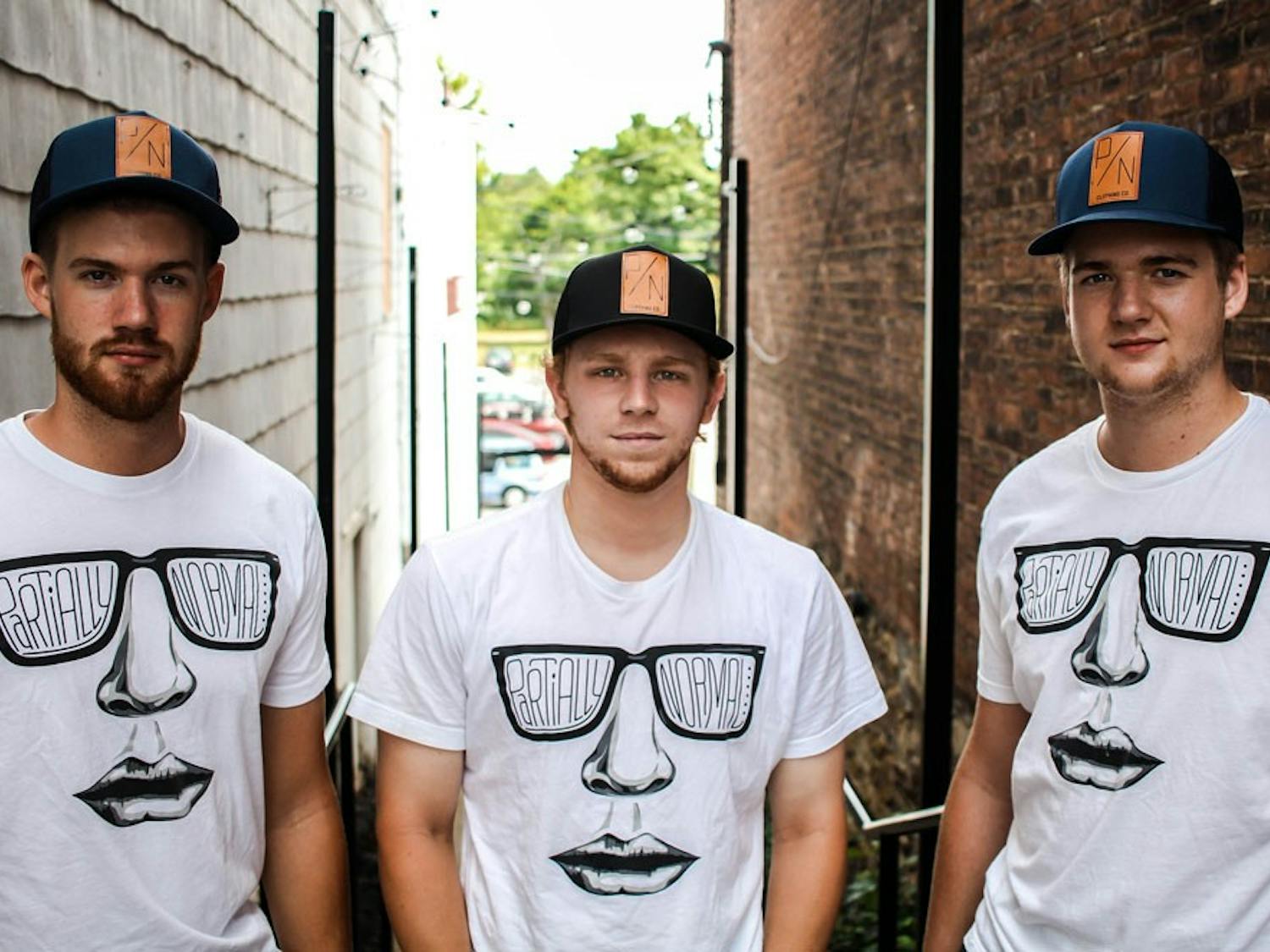 Brendan Cox, Ryan Thompson and Evan Cox the creators of Partially Normal Clothing. They currently have hats and t-shirts for sale but plan to include hoodies in their upcoming fall lineup.