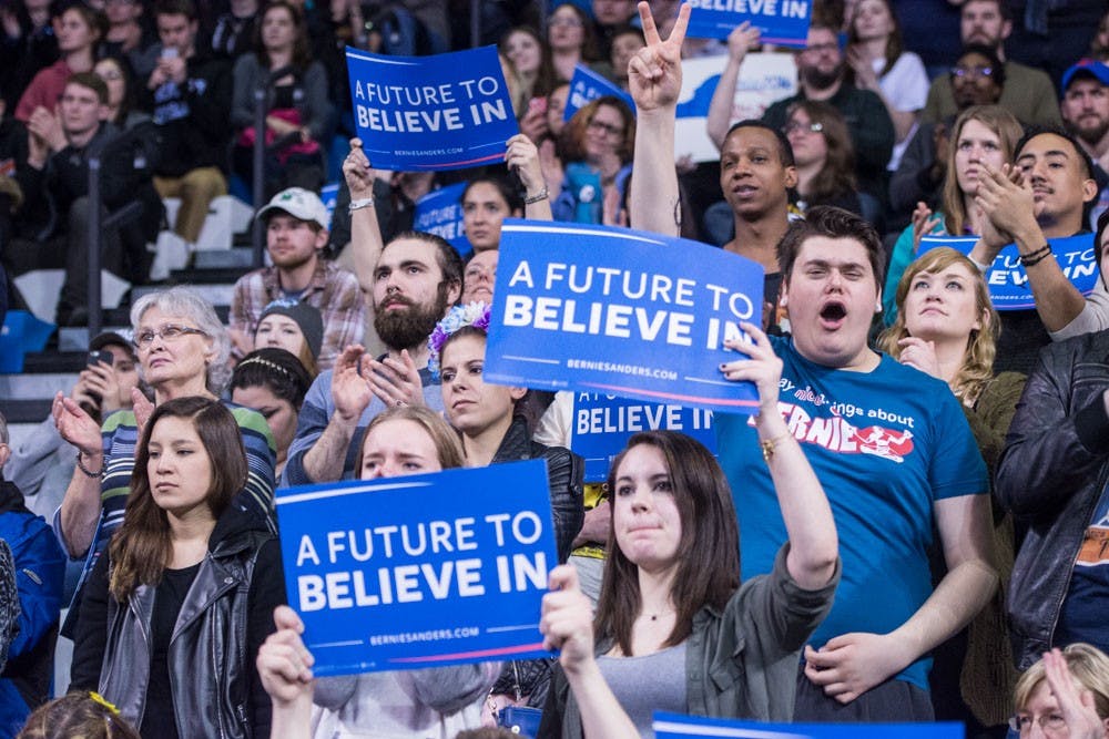 <p>Supporters cheer on Bernie Sanders in Alumni Arena Monday night.&nbsp;</p>