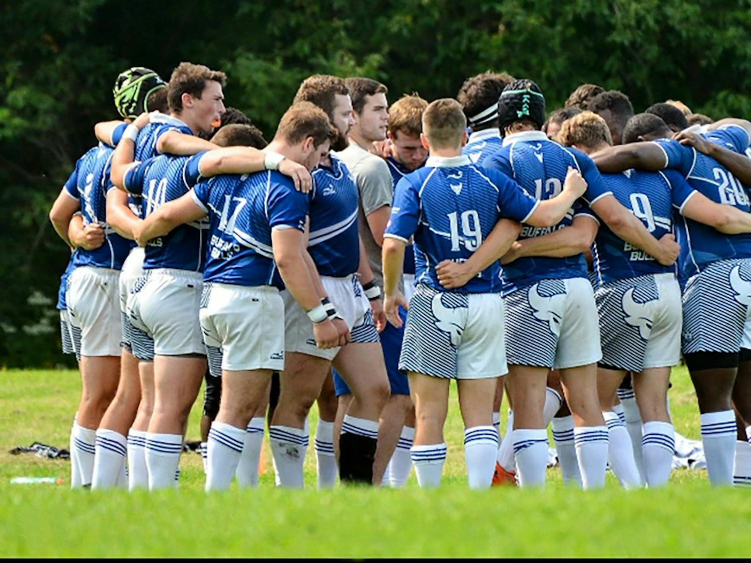 The men's rugby team comes together before the start of their game. The Bulls look to keep improving and establish themselves as a premier team in the country.