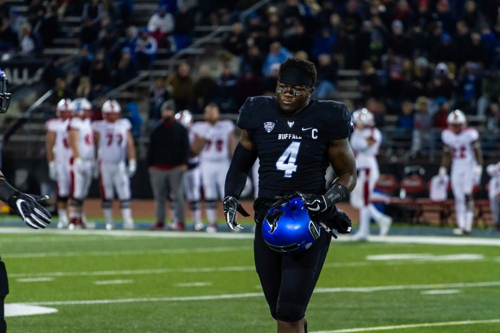 <p>Senior linebacker Khalil Hodge walks toward the sidelines after a targeting penalty. Hodge will miss the first half of the game against Kent State due to the penalty.&nbsp;</p>