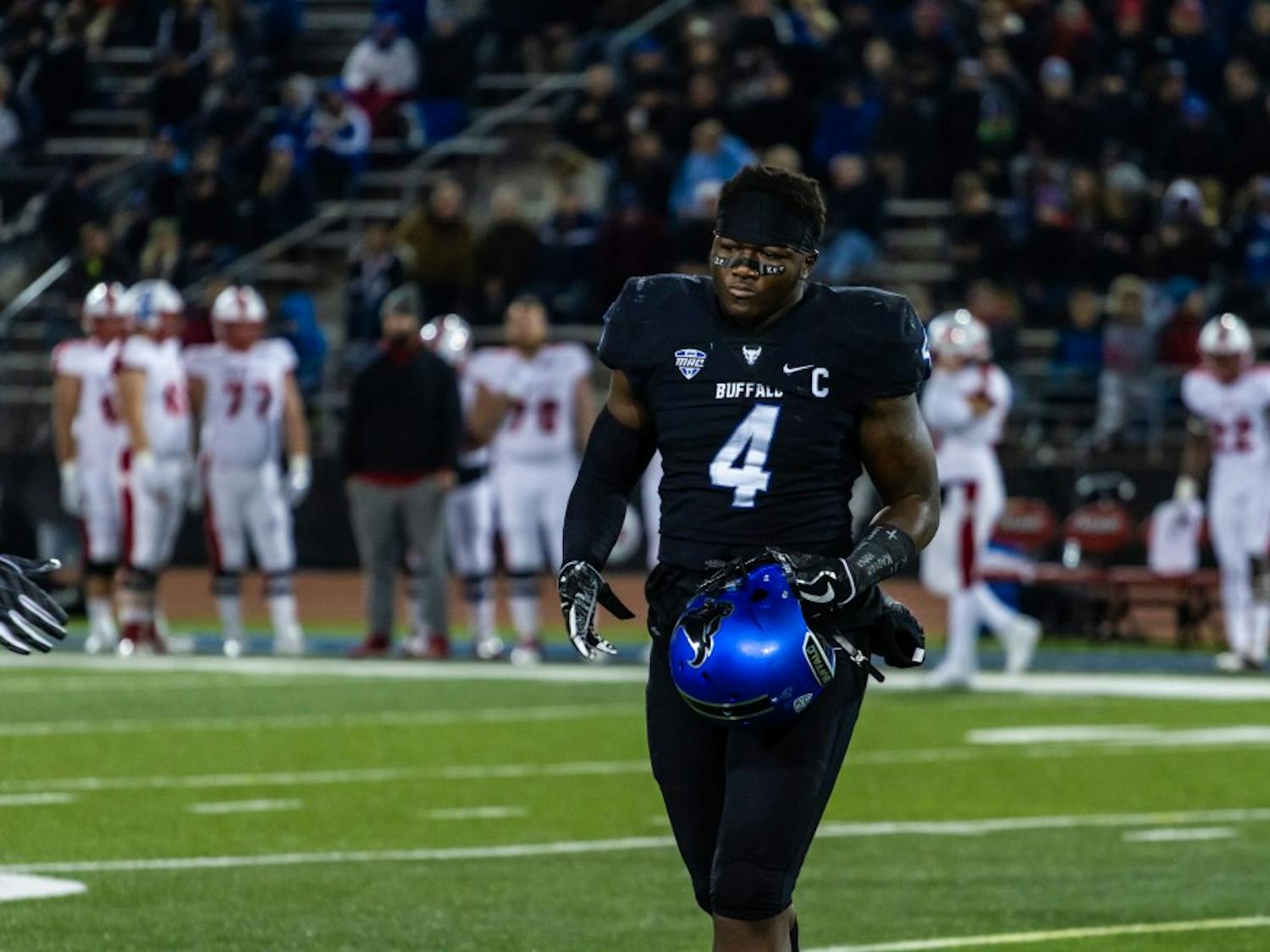 Senior linebacker Khalil Hodge walks toward the sidelines after a targeting penalty. Hodge will miss the first half of the game against Kent State due to the penalty.&nbsp;