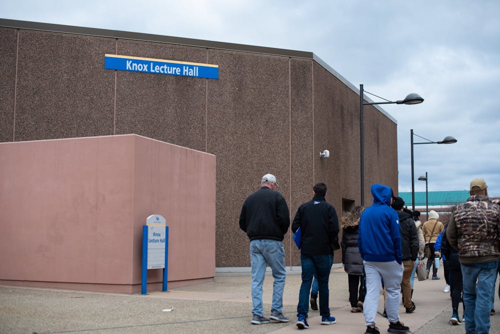 A tour walks outside of Knox Hall Friday.