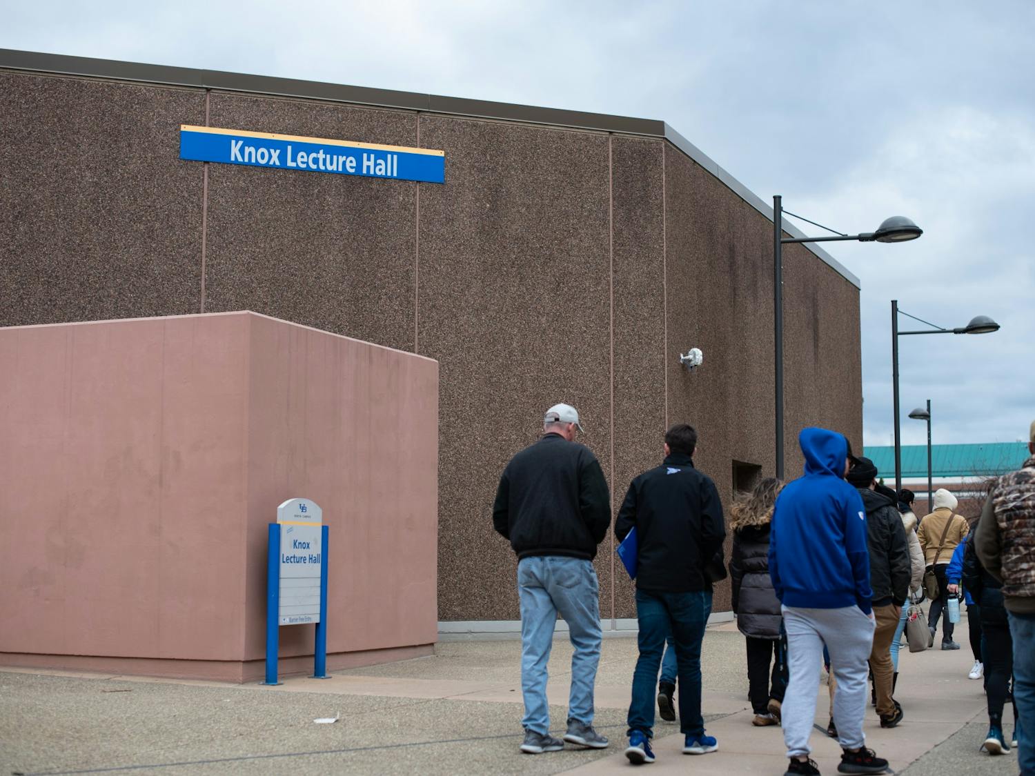 A tour walks outside of Knox Hall Friday.