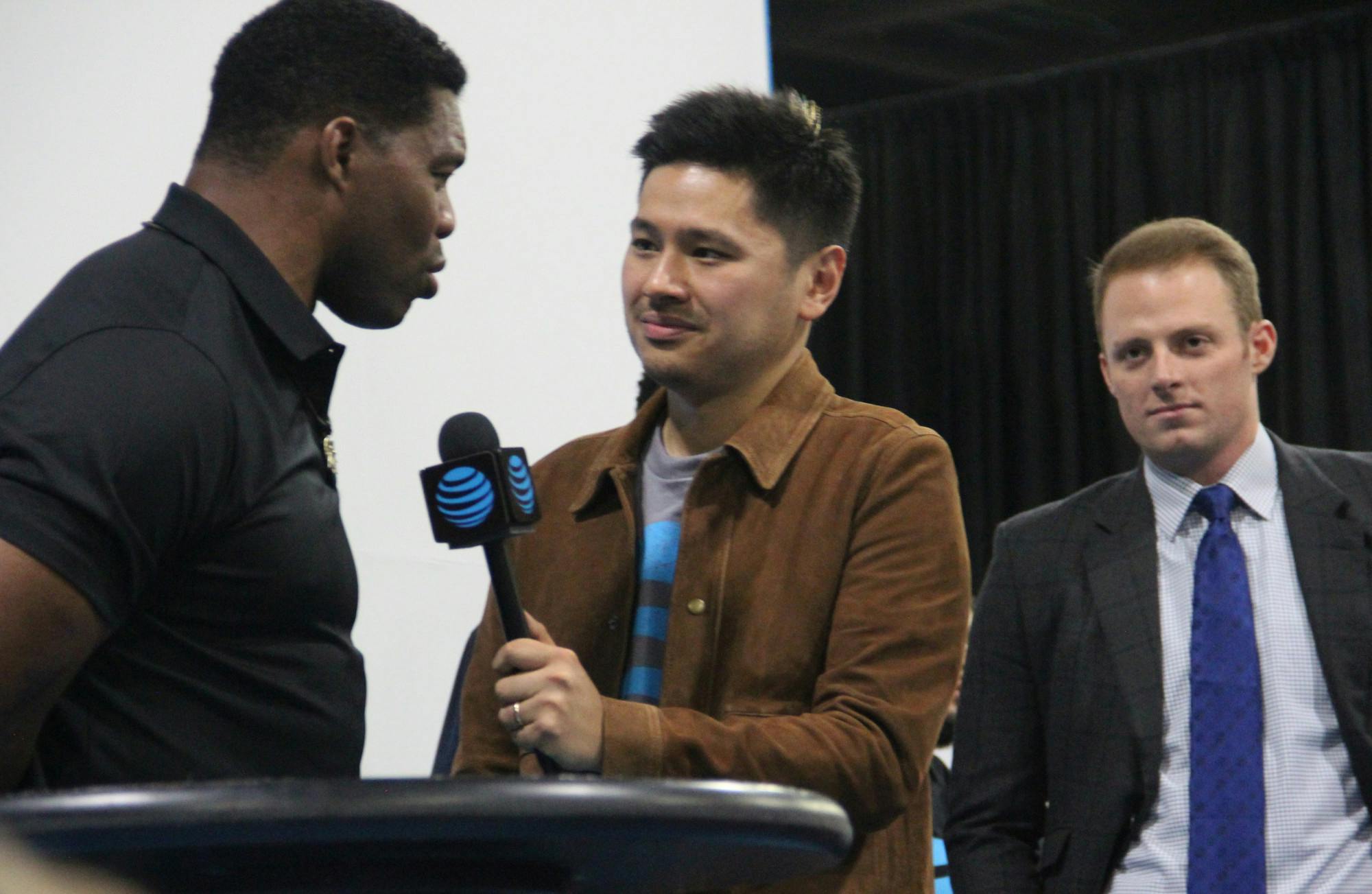 Pablo Torres (middle) interviews Herschel Walker (left) with Greg McElroy (right) in the background in 2018. 