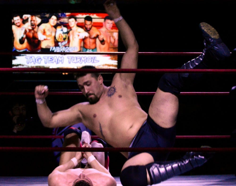 Graig Knowlton delivers an elbow to the chest of "The Red Death" Daniel Garcia. Knowlton works as a deliveryman and hauls 20-foot rubber mats when not wrestling.