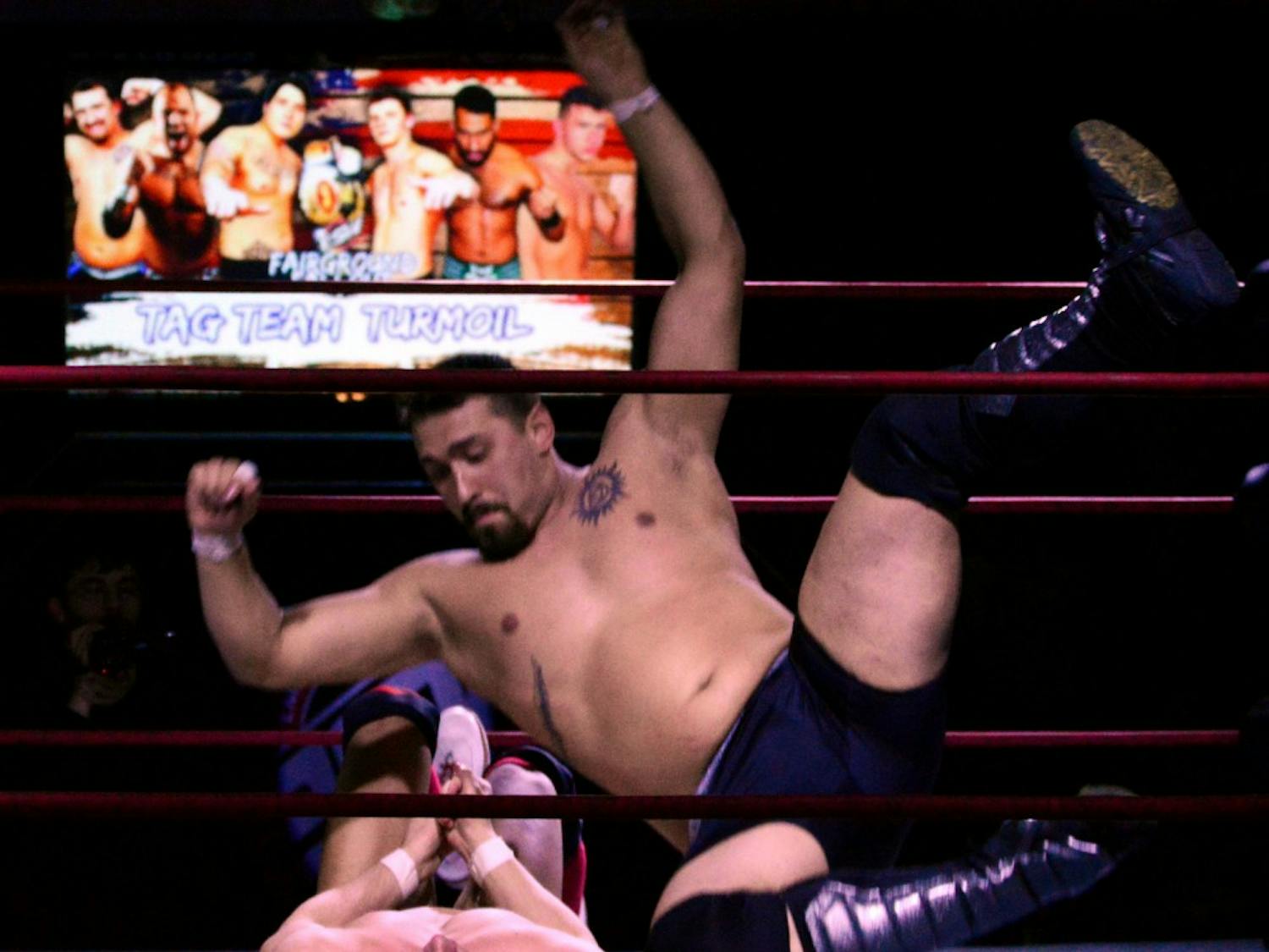 Graig Knowlton delivers an elbow to the chest of "The Red Death" Daniel Garcia. Knowlton works as a deliveryman and hauls 20-foot rubber mats when not wrestling.