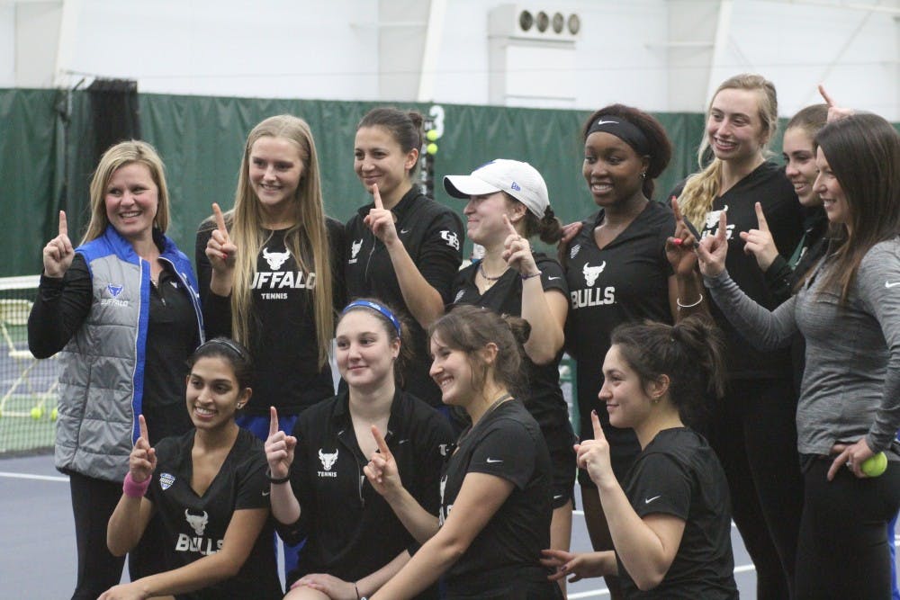 The Bulls celebrate after beating the Ball State Cardinals 7-0 Friday. The program earned its first MAC Season Championship with the win.