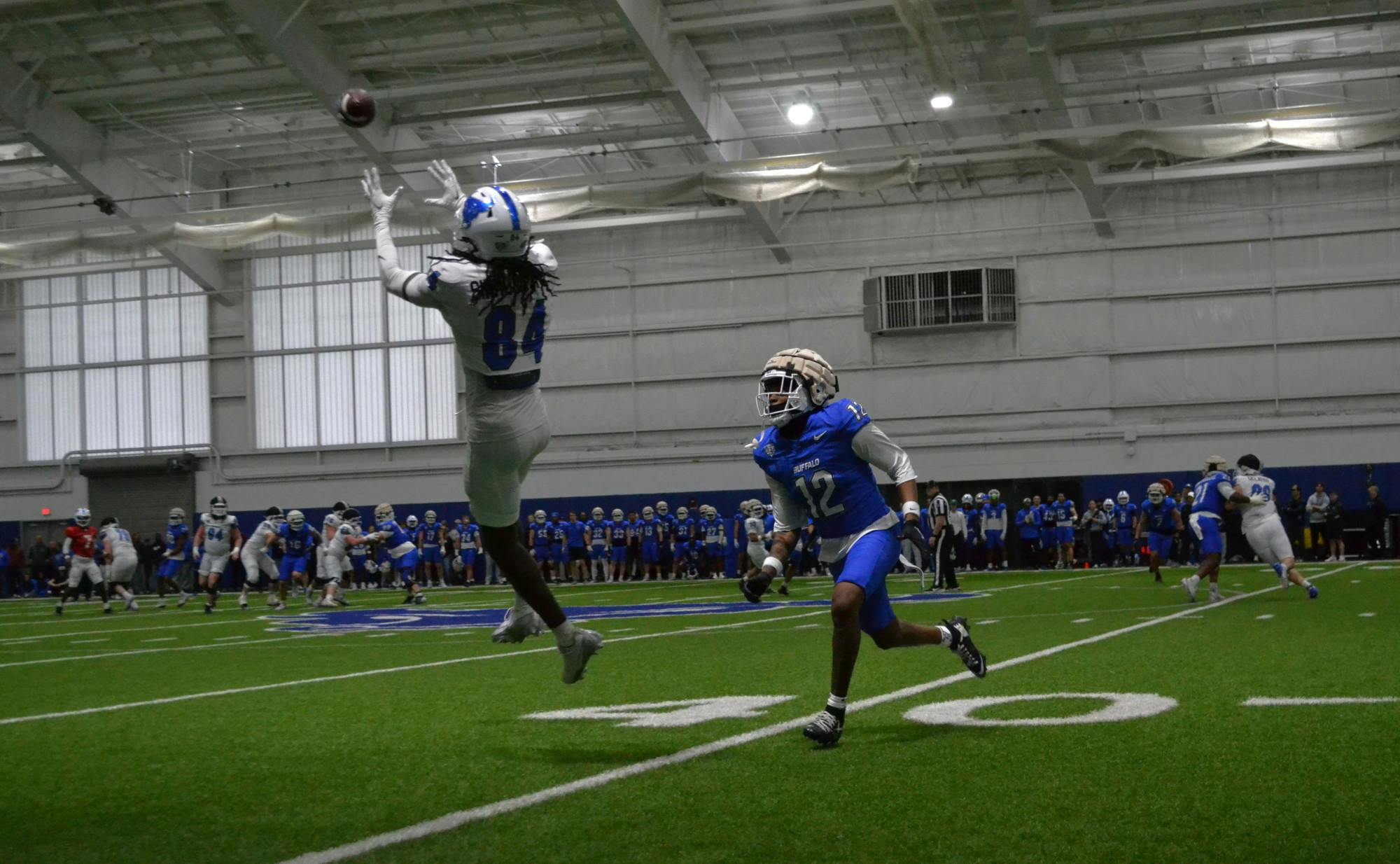 UB football team practicing for the annual spring scrimmage