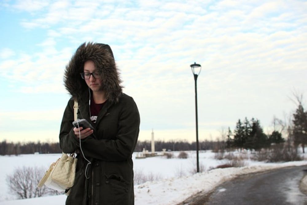 Jessie Nagler, a senior dance major and nutrition minor, walks through across UB&rsquo;s snowy North Campus. Buffalo hasn&rsquo;t provided students with an easy winter so far, and many students are experiencing difficulty driving safely to classes.&nbsp;Andy Koniuch, The Spectrum