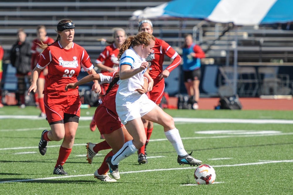 <p>Freshman midfielder Nicole Gerritz gets past Northern Illinois defenders. The Bulls went 1-1 on the weekend and have two games remaining before the Mid-American Conference Tournament</p>