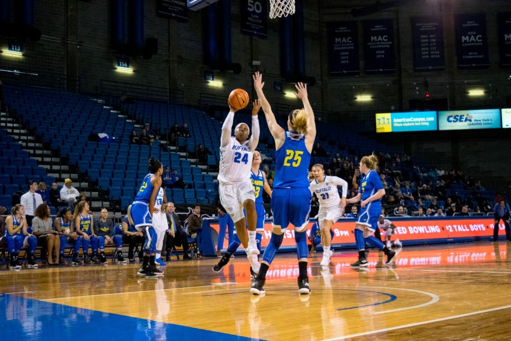 <p>Senior guard Cierra Dillard shoots a floater over a Delaware defender. Dillard strives to emulate LeBron James in her playstyle.</p>
