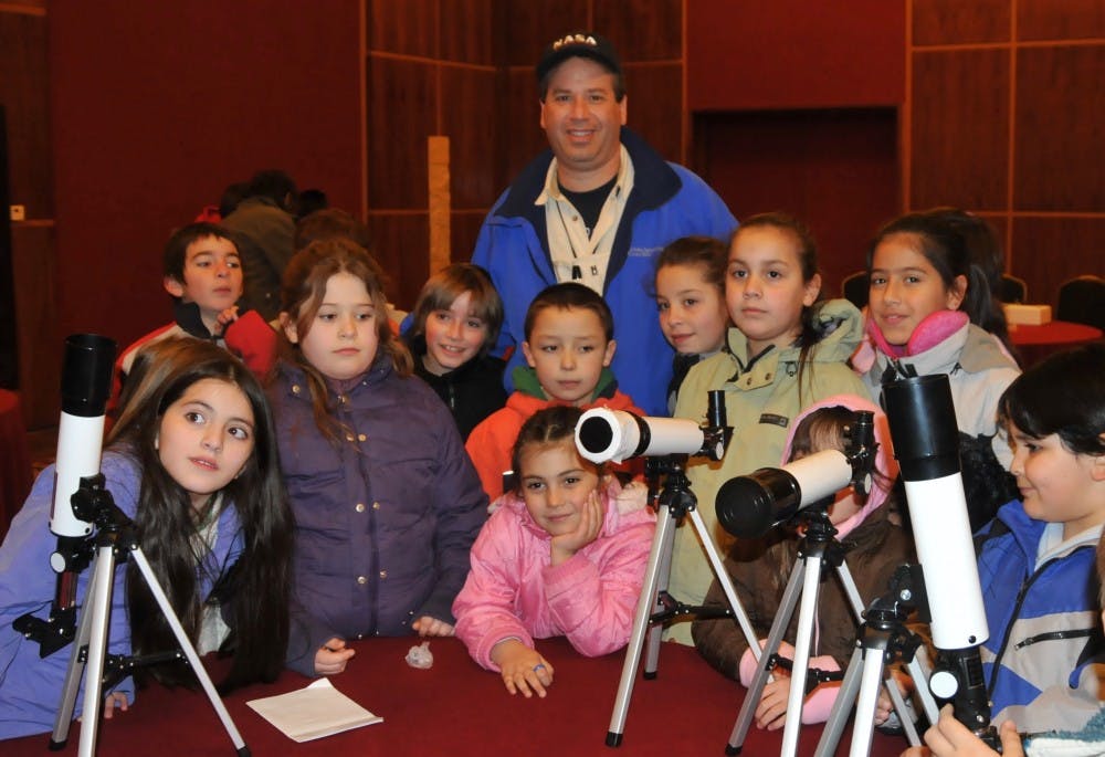 <p>Charles Fulco surrounded by some of his students from Port Chester Middle School. Fulco is currently traveling the United States educating students on solar eclipses.</p>