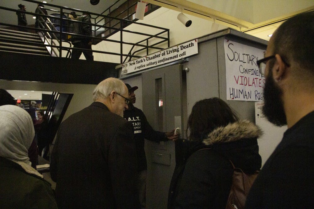 <p>&nbsp;Members of Campaign for Alternatives to Isolated Confinement at the door of the imitation solitary confinement cell.&nbsp;</p>