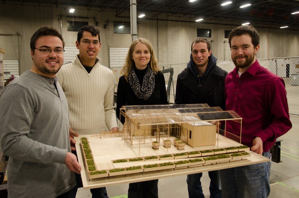 <p>(From left to right) Joe Tuberdyck, Matt Kreidler, Martha Bohm (Faculty Advisor), Nate Heckman, and Christopher Osterhoudt, around the model for the GRoW House at the Riverview Solar Technology Park.</p>