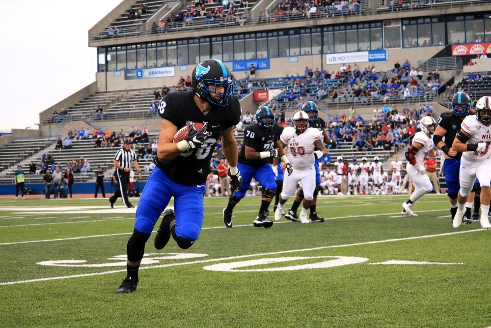 <p>Senior receiver Jacob Martinez runs with the ball. The Bulls lost a close game 14-13 to the Northern Illinois Huskies. </p>