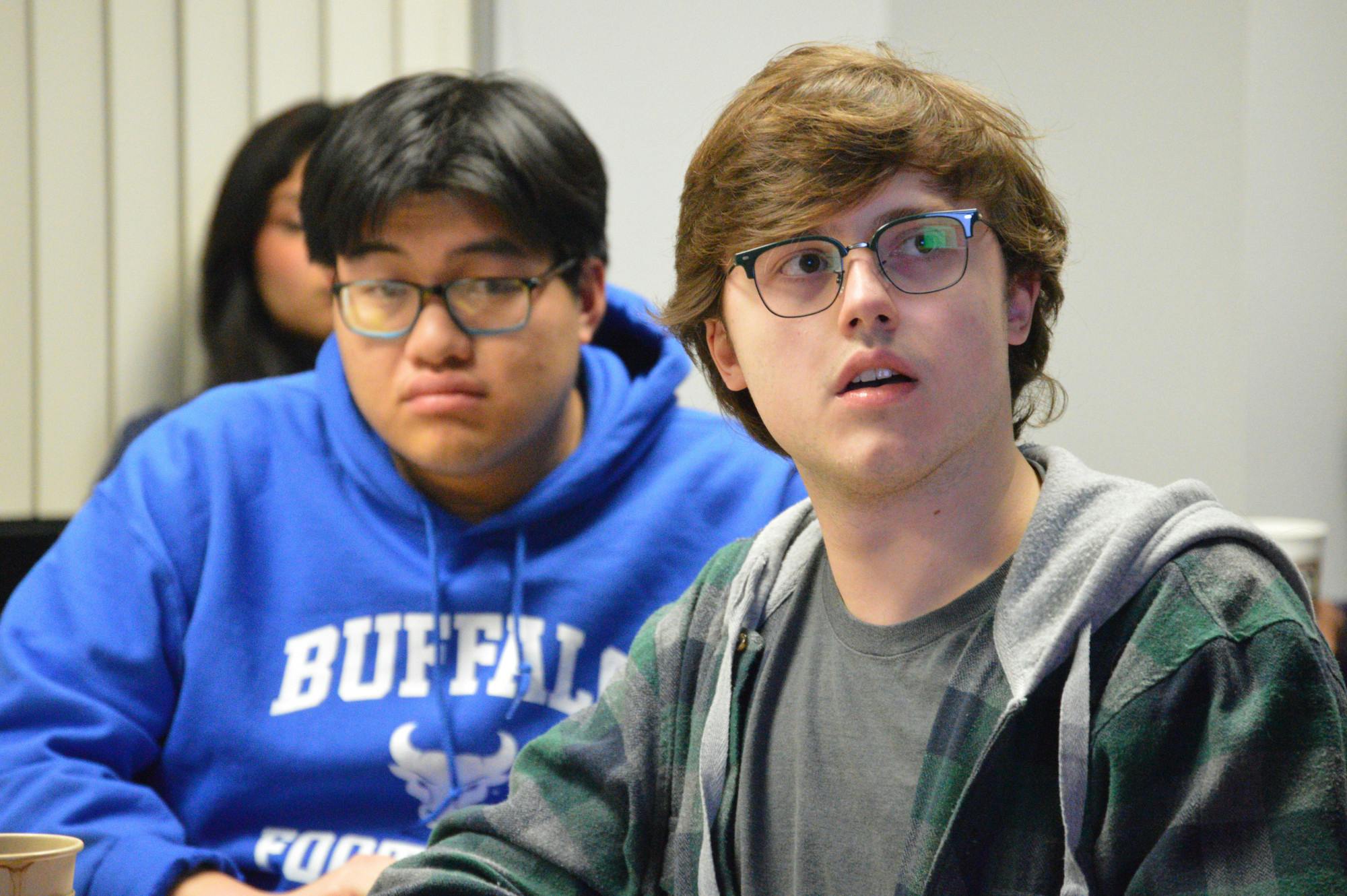  SA Senator Grant Peterson (right) reads the resolution to broadly support the spaces on the room’s TV screen.