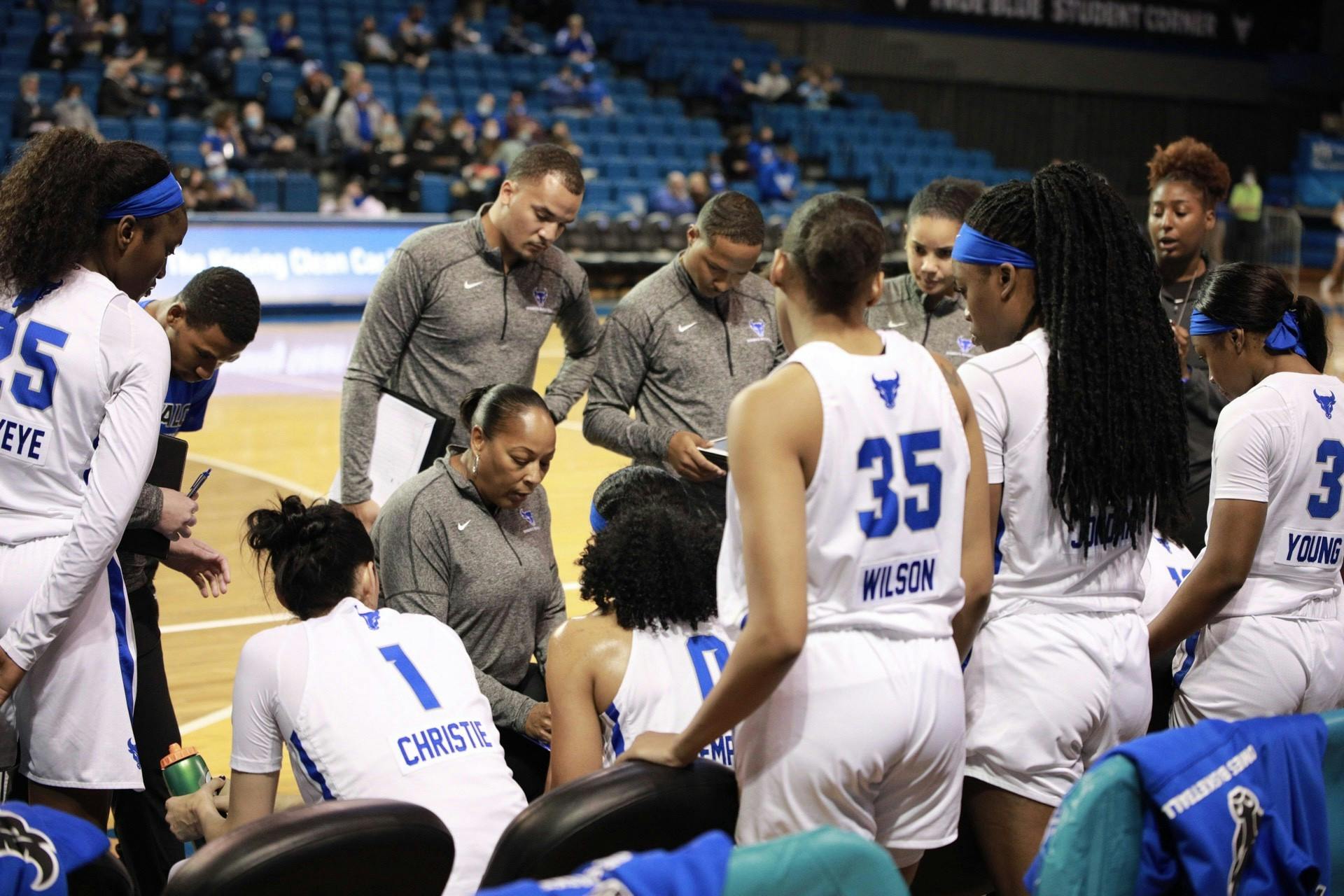 Loren Christie (1), Kaelonn Wilson (35), Jazmine Young (3) and others look on as head coach Felisha Legette-Jack talks to her team during the Bulls' 85-49 victory over Mercyhurst Thursday.