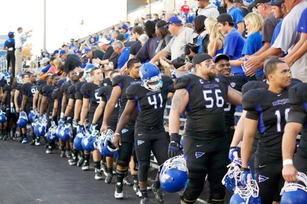The football team celebrates with fans at UB Stadium after defeating Connecticut on Sept. 28 2013. ESPN and the MAC announced a 13-year media rights extension on Aug. 19. Chad Cooper, The Spectrum