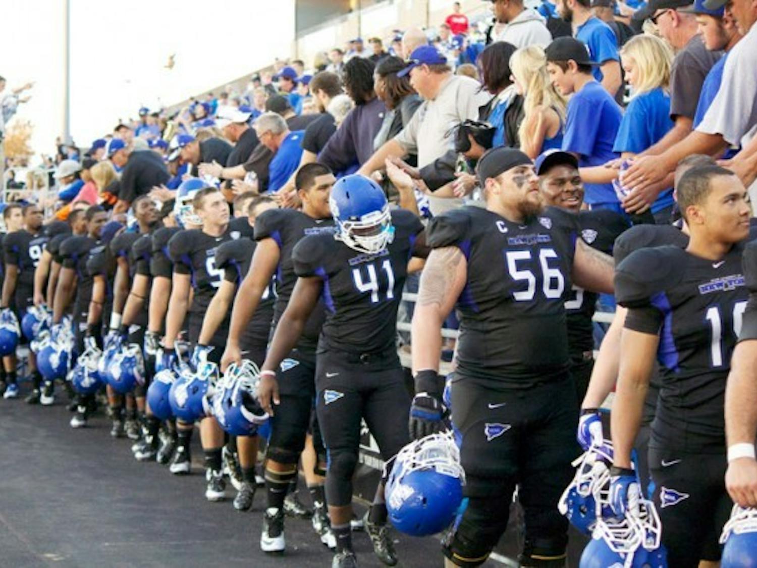 The football team celebrates with fans at UB Stadium after defeating Connecticut on Sept. 28 2013. ESPN and the MAC announced a 13-year media rights extension on Aug. 19. Chad Cooper, The Spectrum