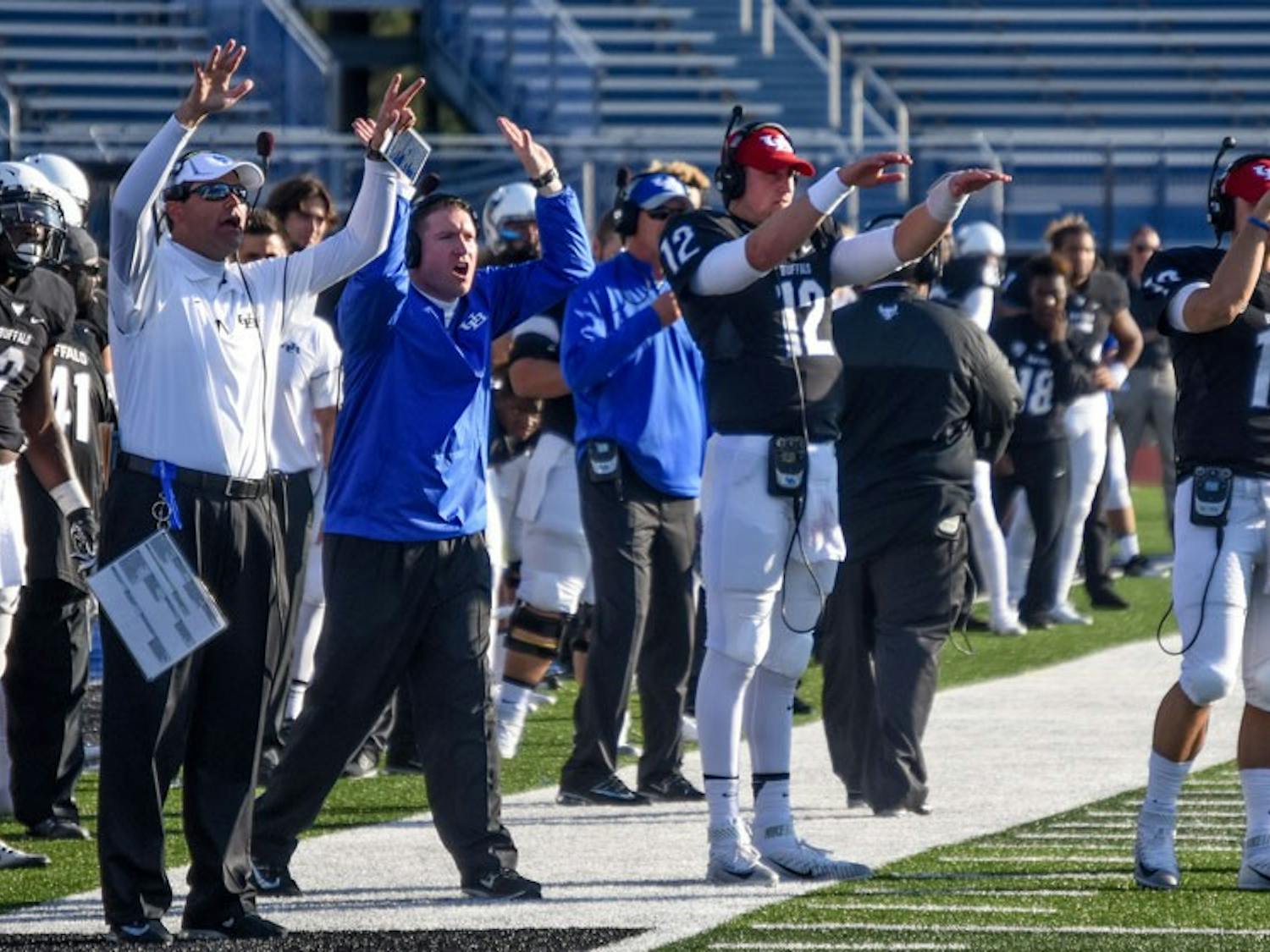 UB football coaches and players stand on the sideline.&nbsp;UB football was blown out Saturday by Northern Illinois and are 0-3 in the MAC this season.