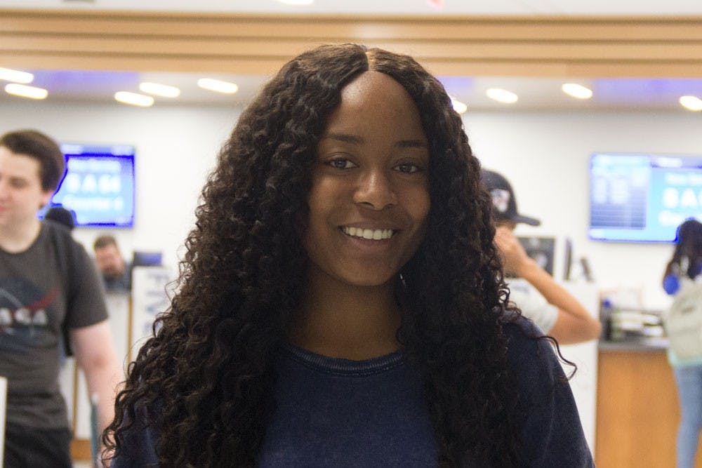 <p>Chelsey Omoma, a social sciences major, stands in 1Capen. Omoma is happy about 1Capen’s opening but would like to see an improvement in wait times.</p>