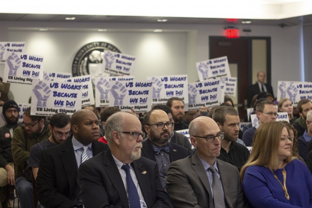 <p>Graham Hammill (front center),&nbsp;vice provost for Graduate Education and dean of the Graduate School, sits among other UB administrators as Living Stipend movement members protest behind him.<br>
</p>