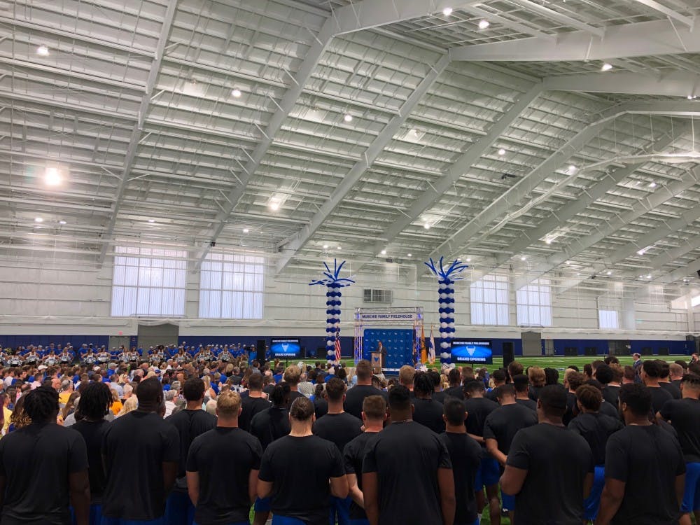 The UB football team watches on during a speech at the Murchie Family Fieldhouse grand opening Tuesday.