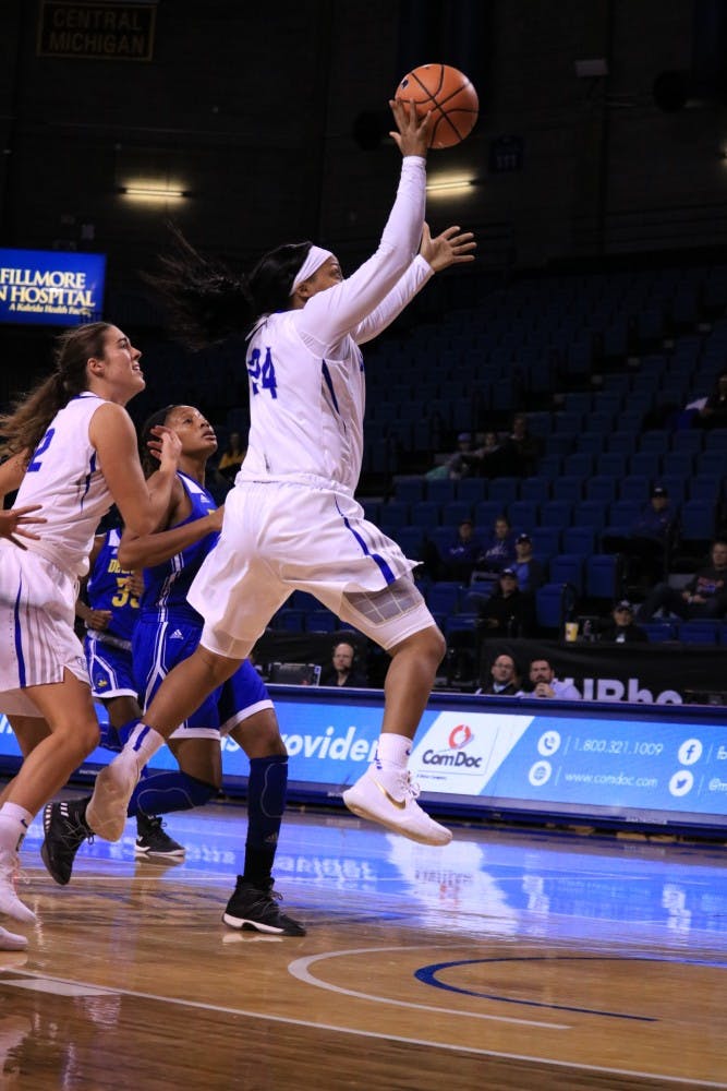 Senior guard Cierra Dillard goes for the layup while pressed in the paint. Dillard was the lead scorer for the Bulls last season and hopes to improve.