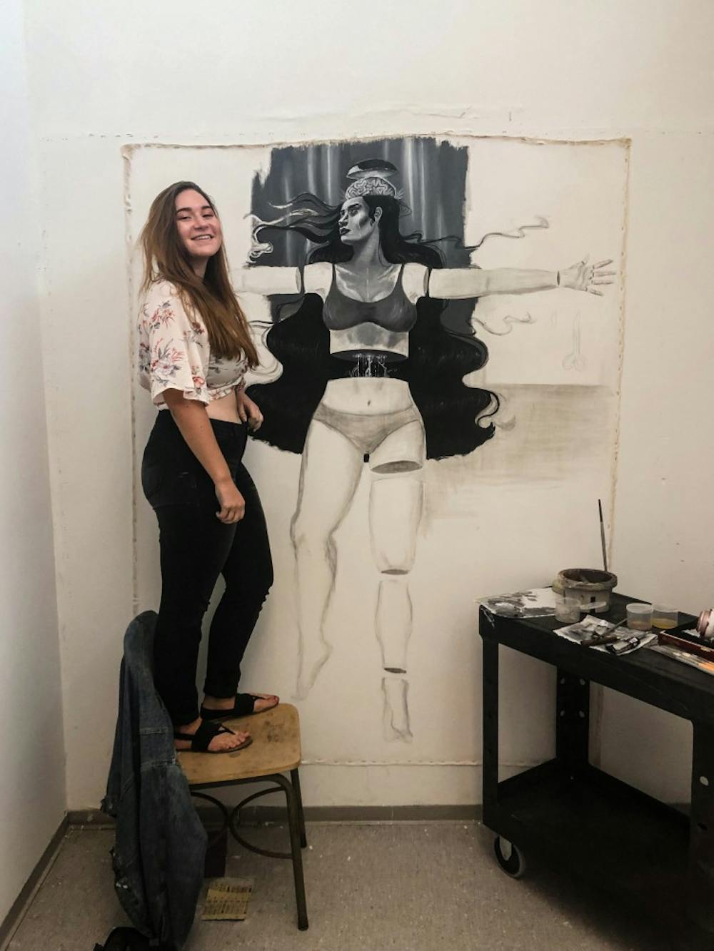 <p>Emily Quartley poses with her life-sized drawing.</p>