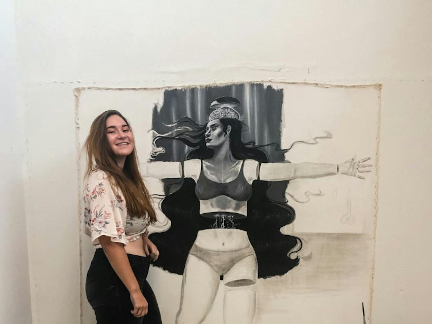 Emily Quartley poses with her life-sized drawing.
