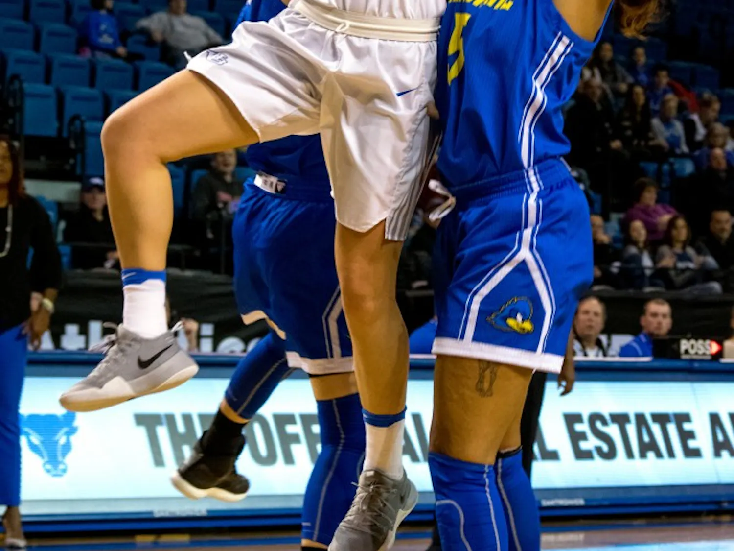 Senior guard Lisa Ups works around two Kent State defenders to make a layup. The Bulls beat Kent State 80-42 at home on Wednesday.