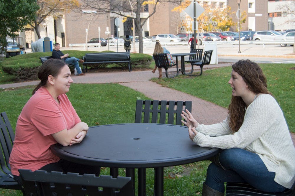 <p>Danielle Dispenza (right) and Sarah Fullington (left) sit outside of the Student Union. Dispenza said she will vote for Hillary Clinton due to her disdain for Donald Trump and Fullington said she will not vote at all.</p>